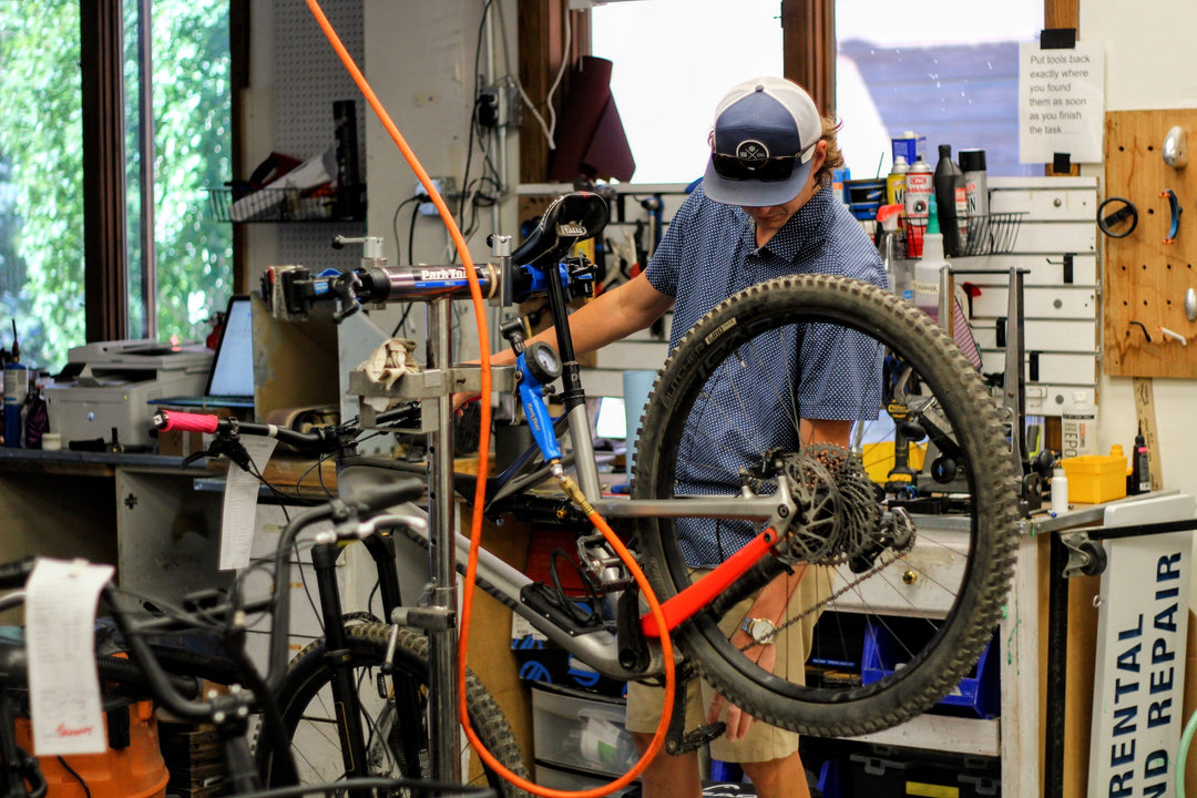 Bike mechanic serving a bike at Switchback Sports in Park City 